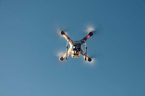 le roy low angle photography of RC quadcopter at mid air airplane